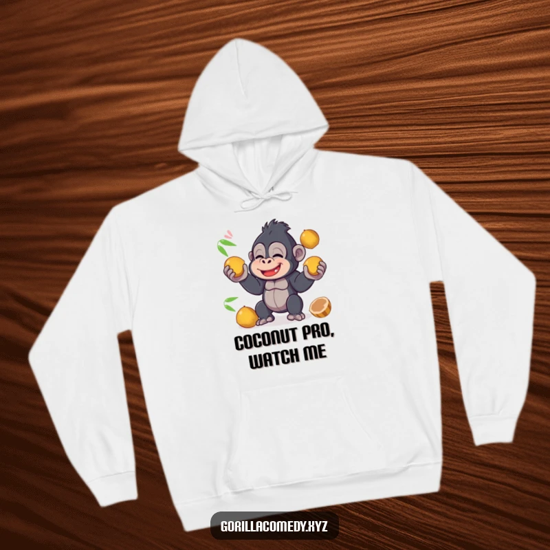 A giggling funny kawaii gorilla is skillfully juggling coconuts, depicted on a warm and cozy hoodie for ultimate comfort and amusement.
